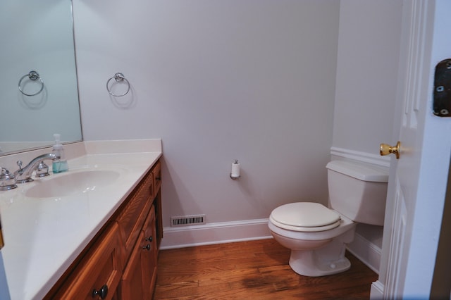 902 Patriots Pt, Mccormick, SC 29835 - half bathroom featuring toilet, vanity, baseboards, and wood finished floors