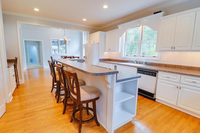 902 Patriots Pt, Mccormick, SC 29835 - kitchen featuring white appliances, a breakfast bar area, a sink, a center island, and crown molding