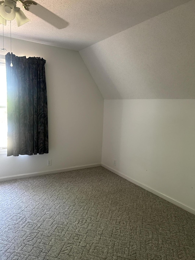 902 Patriots Pt, Mccormick, SC 29835 - bonus room with a textured ceiling, ceiling fan, carpet, vaulted ceiling, and baseboards