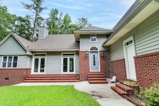 902 Patriots Pt, Mccormick, SC 29835 - doorway to property featuring a chimney, brick siding, and a yard