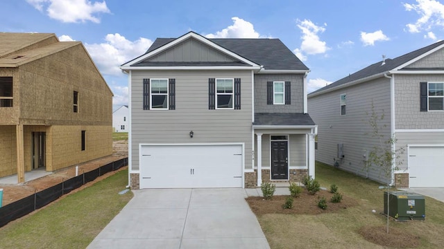 craftsman inspired home with cooling unit, a garage, and a front yard