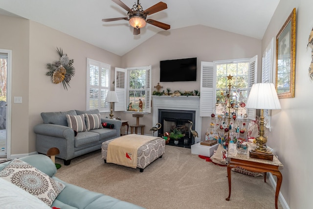 carpeted living room featuring ceiling fan and vaulted ceiling