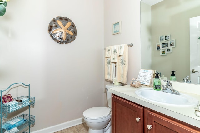 bathroom with tile patterned flooring, vanity, and toilet