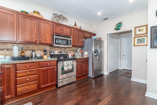 kitchen featuring dark hardwood / wood-style flooring, backsplash, and stainless steel appliances