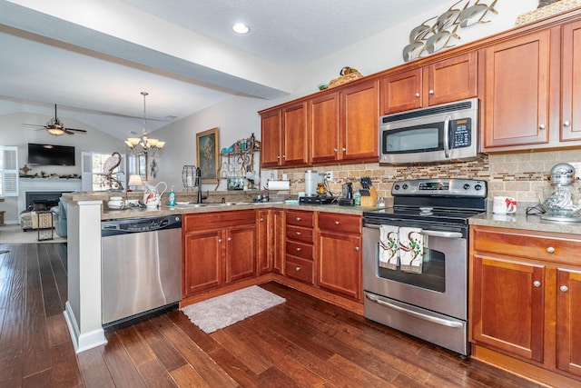 1215 Brookstone Way, Augusta, GA 30909 - kitchen featuring stainless steel appliances, a peninsula, open floor plan, dark wood finished floors, and brown cabinets