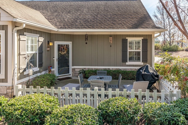 1215 Brookstone Way, Augusta, GA 30909 - entrance to property featuring stone siding, roof with shingles, board and batten siding, and a patio area
