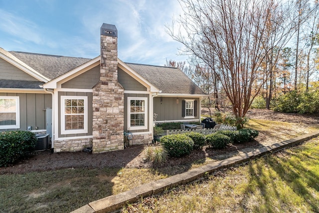 1215 Brookstone Way, Augusta, GA 30909 - view of front of home featuring board and batten siding, a chimney, and a shingled roof