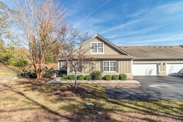 view of front of home with a front yard and a garage