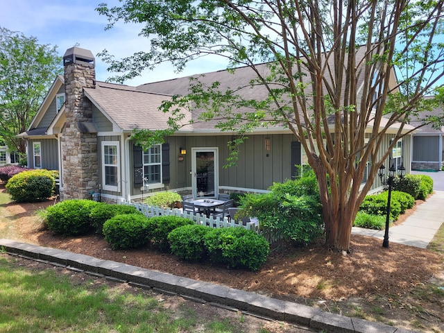 1215 Brookstone Way, Augusta, GA 30909 - view of front of home featuring board and batten siding, a shingled roof, a chimney, and stone siding