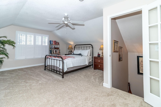 carpeted bedroom featuring a textured ceiling, ceiling fan, and lofted ceiling