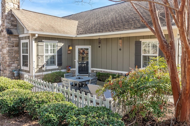 1215 Brookstone Way, Augusta, GA 30909 - entrance to property featuring a shingled roof, a chimney, board and batten siding, and stone siding