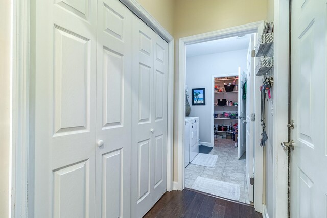 hallway featuring dark wood-type flooring and washing machine and clothes dryer