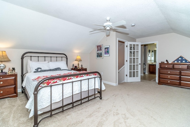 carpeted bedroom featuring ceiling fan, a textured ceiling, and vaulted ceiling