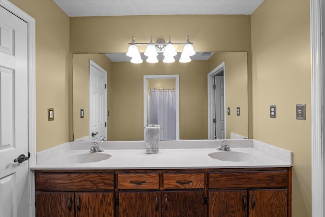 bathroom with a textured ceiling and vanity