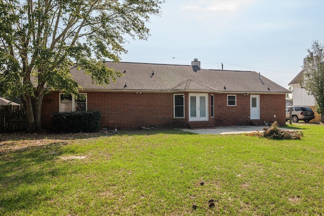 back of house featuring french doors, a yard, and a patio area