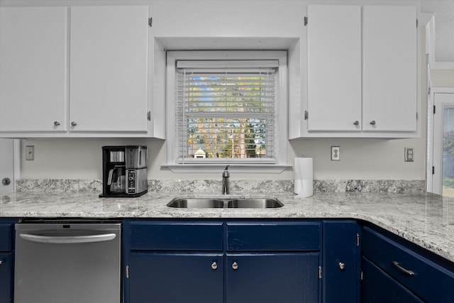 kitchen with white cabinetry, sink, stainless steel dishwasher, and blue cabinets