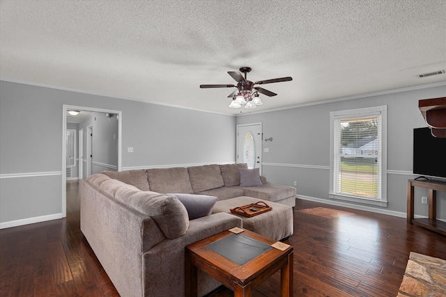 living room with crown molding, dark hardwood / wood-style flooring, ceiling fan, and a textured ceiling