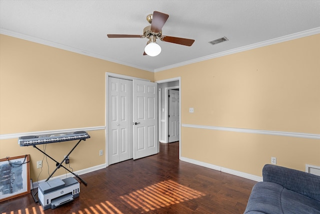 sitting room featuring dark hardwood / wood-style floors, ceiling fan, and crown molding