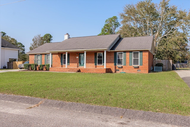 ranch-style house with central AC and a front lawn