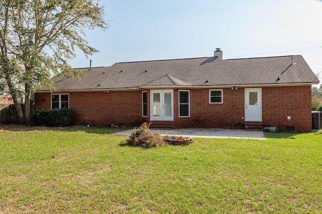 rear view of property featuring a patio area and a yard