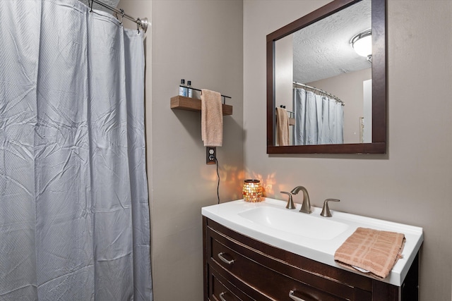 bathroom with vanity, a textured ceiling, and a shower with shower curtain