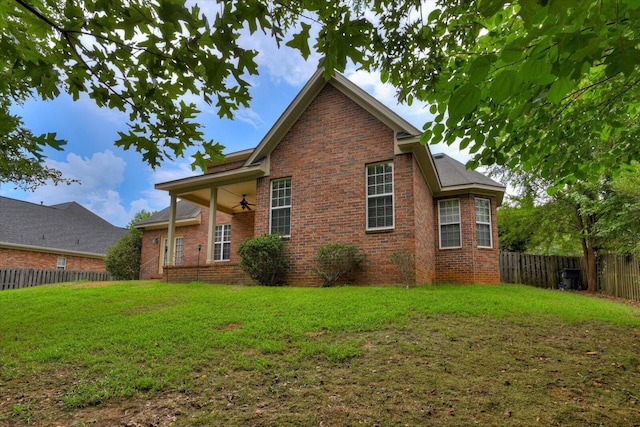 1123 Blackfoot Dr, Evans, GA 30809 - view of home's exterior featuring a ceiling fan, a fenced backyard, and brick siding