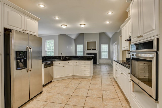 1123 Blackfoot Dr, Evans, GA 30809 - kitchen with stainless steel appliances, a peninsula, recessed lighting, light tile patterned floors, and a fireplace