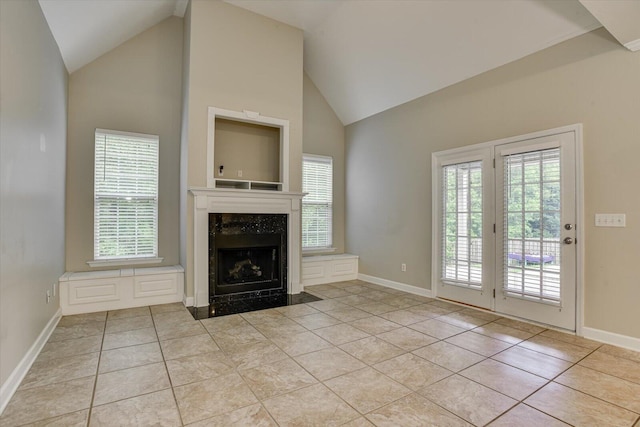 1123 Blackfoot Dr, Evans, GA 30809 - unfurnished living room with a premium fireplace, healthy amount of natural light, light tile patterned floors, and high vaulted ceiling