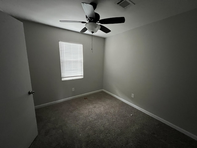 unfurnished room featuring dark colored carpet and ceiling fan