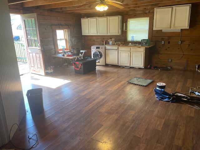 kitchen featuring wood walls, hardwood / wood-style floors, ceiling fan, and washer / dryer