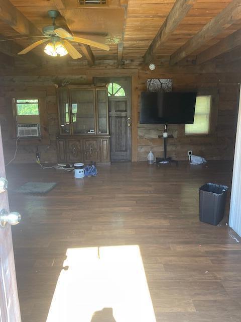 interior space featuring beam ceiling, dark hardwood / wood-style flooring, cooling unit, and wood ceiling