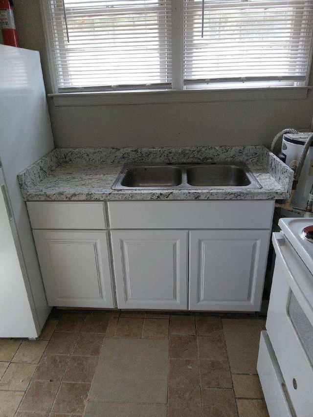 bathroom featuring tile patterned flooring and sink