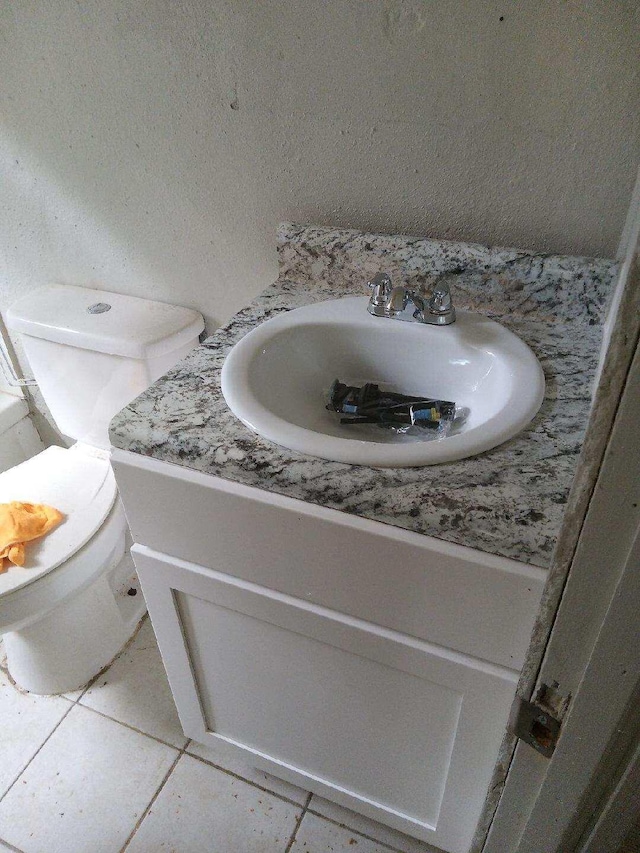 bathroom with tile patterned floors, vanity, and toilet