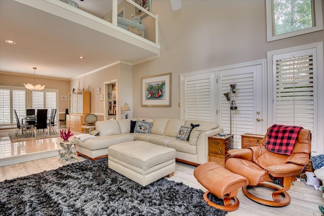3725 Wexford Dr, Martinez, GA 30907 - living area featuring wood finished floors, a chandelier, a high ceiling, and crown molding