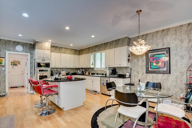 3725 Wexford Dr, Martinez, GA 30907 - kitchen featuring appliances with stainless steel finishes, light wood-type flooring, white cabinets, a kitchen island, and recessed lighting