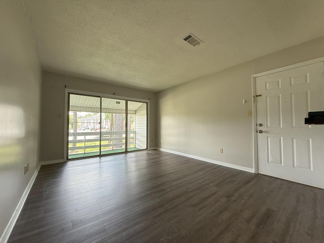 1017 Stevens Creek Rd, Augusta, GA 30907 - empty room featuring dark wood-type flooring and a textured ceiling
