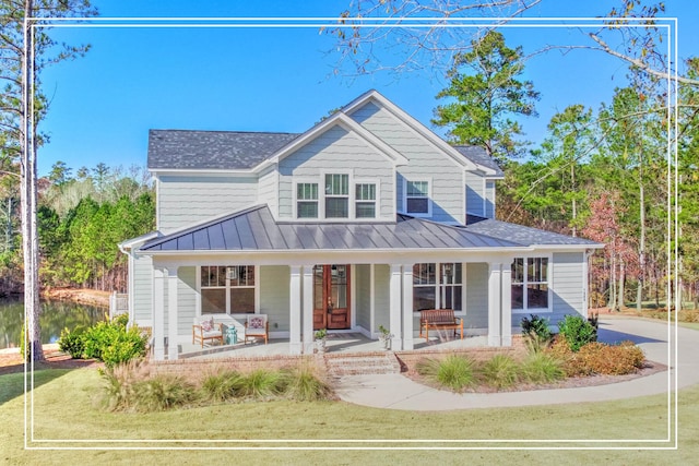 view of front of home featuring covered porch and a front yard