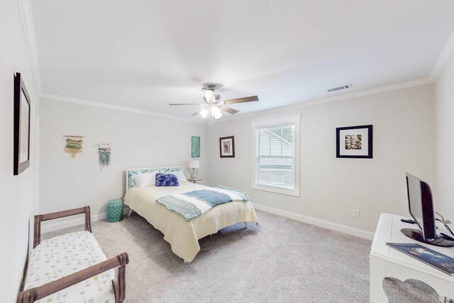 carpeted bedroom with ceiling fan and ornamental molding