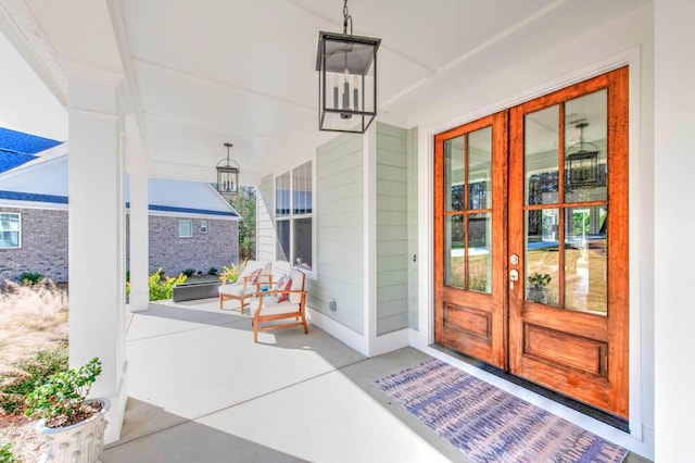 doorway to property featuring french doors and covered porch