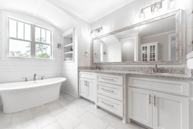 bathroom with tile patterned floors, vanity, a bath, and ornamental molding