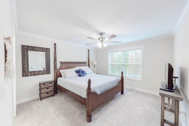 bedroom featuring light carpet, ceiling fan, and crown molding