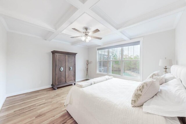 bedroom featuring beam ceiling, light hardwood / wood-style flooring, ceiling fan, and coffered ceiling