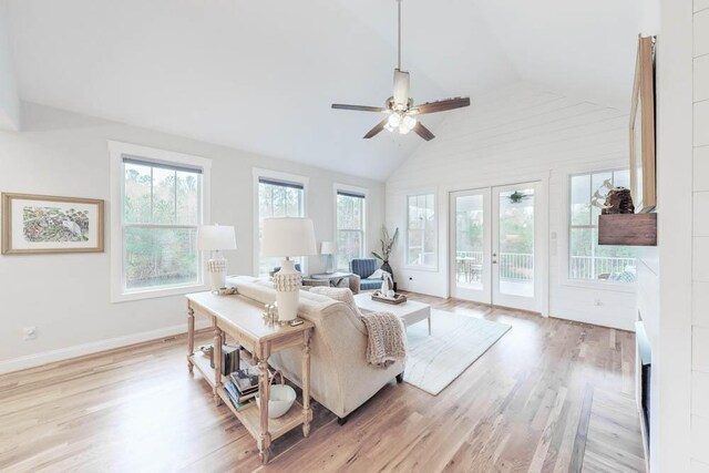 living room featuring french doors, high vaulted ceiling, light hardwood / wood-style flooring, and ceiling fan