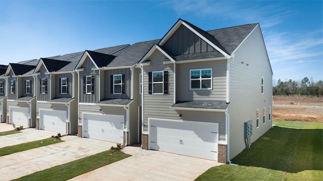 multi unit property featuring a garage and a front lawn