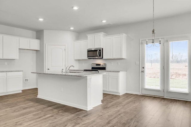 kitchen featuring pendant lighting, sink, white cabinets, and stainless steel appliances