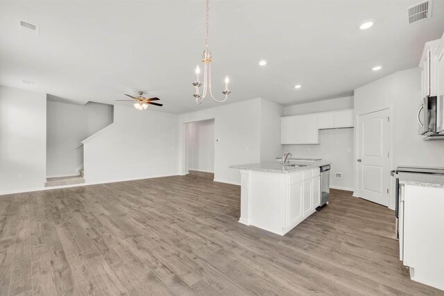 kitchen with a center island with sink, light wood-type flooring, white cabinetry, and stainless steel appliances