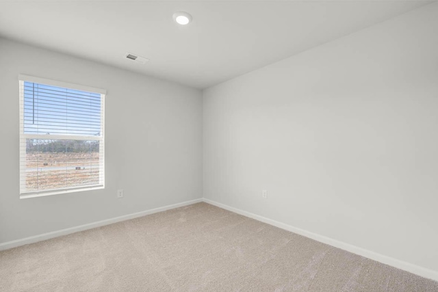 carpeted spare room featuring a healthy amount of sunlight