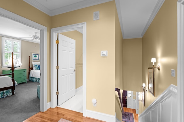 1201 Reid Rd, Augusta, GA 30909 - hall featuring an upstairs landing, crown molding, visible vents, baseboards, and wood finished floors