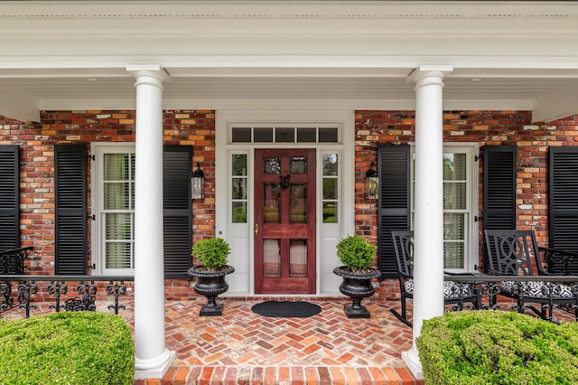 1201 Reid Rd, Augusta, GA 30909 - doorway to property featuring covered porch and brick siding