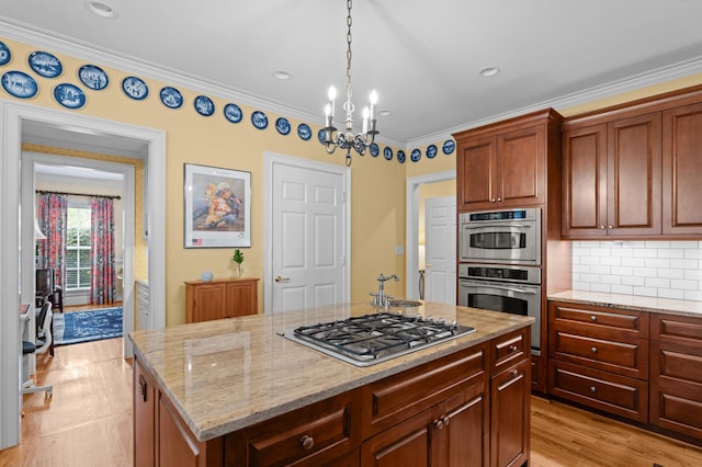 1201 Reid Rd, Augusta, GA 30909 - kitchen featuring light stone counters, a chandelier, stainless steel appliances, a sink, and crown molding